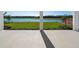 Covered patio with scenic views of the green lawn, lake, and golf course providing a tranquil outdoor space at 15610 San Lazzaro Ave, Bradenton, FL 34211