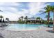 Expansive community pool featuring a Bahama Bar and ample lounge seating under sunny skies at 15610 San Lazzaro Ave, Bradenton, FL 34211