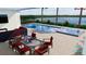 Outdoor pool area with a built-in jacuzzi, patio furniture, and scenic water views at 15610 San Lazzaro Ave, Bradenton, FL 34211