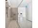 Spacious walk-in shower with dual shower heads, a built-in seat, and modern tile at 15610 San Lazzaro Ave, Bradenton, FL 34211