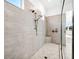 This large shower has dual shower heads, a built-in seat, and stylish fixtures at 15610 San Lazzaro Ave, Bradenton, FL 34211