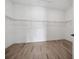 Spacious walk-in closet with wire shelving and wood-look tile flooring at 15610 San Lazzaro Ave, Bradenton, FL 34211