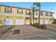 Townhouse with two-car garage and landscaped front at 1605 Napoli W Dr, Sarasota, FL 34232
