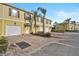 Townhouse with two-car garage and palm trees at 1605 Napoli W Dr, Sarasota, FL 34232