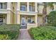 Townhouse entrance with a wrought iron gate and a brick pathway at 1605 Napoli W Dr, Sarasota, FL 34232