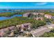 Aerial showcasing community near waterfront, lush landscape, and ocean views at 1719 Starling Dr # 1719, Sarasota, FL 34231