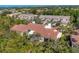 Aerial view showcasing the home's tile roof and lush, green surroundings at 1719 Starling Dr # 1719, Sarasota, FL 34231