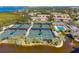 Aerial view of community with tennis courts, pool, and lush landscaping at 1719 Starling Dr # 1719, Sarasota, FL 34231