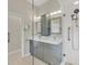 Updated bathroom with double vanity, glass shower, and grab bars at 1719 Starling Dr # 1719, Sarasota, FL 34231