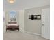 Bedroom with large window, wall-mounted TV, and carpet at 1719 Starling Dr # 1719, Sarasota, FL 34231