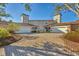Two-story townhomes with white garage doors and brick driveway at 1719 Starling Dr # 1719, Sarasota, FL 34231
