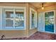 Front entry with blue door, white trim, and brick walkway at 1719 Starling Dr # 1719, Sarasota, FL 34231