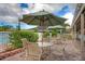 Relaxing poolside patio furniture under umbrellas at 1719 Starling Dr # 1719, Sarasota, FL 34231