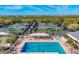 Community pool and tennis courts with ample lounge chairs and shade structures at 1719 Starling Dr # 1719, Sarasota, FL 34231