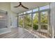 Bright sunroom with wood-look floors and sliding glass doors leading to tranquil nature views at 1719 Starling Dr # 1719, Sarasota, FL 34231
