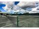 Well-maintained tennis court with net and striped surface at 1719 Starling Dr # 1719, Sarasota, FL 34231