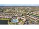 Aerial view of community with lake and homes at 1736 Burgos Dr, Sarasota, FL 34238