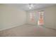 Bedroom with private balcony access, carpet, and ceiling fan at 1736 Burgos Dr, Sarasota, FL 34238