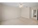 Spacious carpeted bedroom with neutral walls and ceiling fan at 1736 Burgos Dr, Sarasota, FL 34238