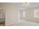 Bright bedroom with carpet flooring, ceiling fan, and access to private bathroom at 1736 Burgos Dr, Sarasota, FL 34238