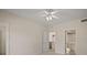 Well-lit bedroom with ceiling fan and access to kitchen and bathroom at 1736 Burgos Dr, Sarasota, FL 34238