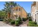 Two-story townhome with inviting walkway, lush landscaping, and a charming facade at 1736 Burgos Dr, Sarasota, FL 34238