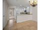 Modern kitchen with white cabinets, stainless steel appliances, and breakfast bar at 1736 Burgos Dr, Sarasota, FL 34238