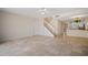 Open living area with tiled floors, kitchen view, and staircase at 1736 Burgos Dr, Sarasota, FL 34238