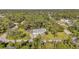 Aerial view showing a single-Gathering house with a spacious yard and surrounding trees at 17402 Billiar Ave, Port Charlotte, FL 33948