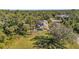 Aerial view of a house with a large backyard, surrounded by lush greenery at 17402 Billiar Ave, Port Charlotte, FL 33948