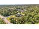 An aerial view of a home with a large backyard and surrounding trees at 17402 Billiar Ave, Port Charlotte, FL 33948
