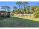 Spacious backyard with screened porch and wooden fence at 17402 Billiar Ave, Port Charlotte, FL 33948
