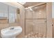 Bathroom with pedestal sink, large shower, and neutral tile at 17402 Billiar Ave, Port Charlotte, FL 33948