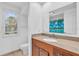 Bathroom with wood vanity, granite countertop, and shower/tub combo at 17402 Billiar Ave, Port Charlotte, FL 33948