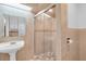 Bathroom with pedestal sink, large shower, and neutral tile at 17402 Billiar Ave, Port Charlotte, FL 33948