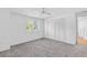 Bright bedroom with grey carpet, ceiling fan, and spacious closet at 17402 Billiar Ave, Port Charlotte, FL 33948