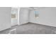 Well-lit bedroom featuring grey carpet and two windows at 17402 Billiar Ave, Port Charlotte, FL 33948
