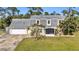 Front view of a two-story house with a gray roof and yellow siding at 17402 Billiar Ave, Port Charlotte, FL 33948