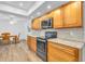 Updated kitchen with wood cabinets, granite counters, and black appliances at 17402 Billiar Ave, Port Charlotte, FL 33948
