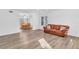 Living room featuring a brown leather couch and wood flooring at 17402 Billiar Ave, Port Charlotte, FL 33948