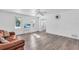 Living room featuring hardwood floors, a brown leather couch, and an open floor plan at 17402 Billiar Ave, Port Charlotte, FL 33948