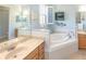 Spa-like bathroom with double vanity, large soaking tub and walk-in shower at 1929 24Th Street W Cir, Palmetto, FL 34221