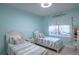 Light blue bedroom with twin beds and coastal decor at 1929 24Th Street W Cir, Palmetto, FL 34221