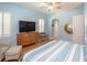 Bedroom with a dresser, bench, and large TV at 1929 24Th Street W Cir, Palmetto, FL 34221