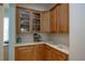Butlers pantry with wood cabinets, coffee maker and sink at 1929 24Th Street W Cir, Palmetto, FL 34221