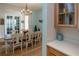 Dining room with wooden table, white chairs and a chandelier at 1929 24Th Street W Cir, Palmetto, FL 34221