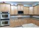 Modern kitchen with stainless steel double ovens and granite countertops at 1929 24Th Street W Cir, Palmetto, FL 34221