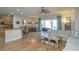 Open floor plan with kitchen island, hardwood floors, and views into the living room at 1929 24Th Street W Cir, Palmetto, FL 34221