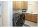 Laundry room with washer, dryer, and overhead cabinets at 1929 24Th Street W Cir, Palmetto, FL 34221
