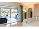 Living area with sliding doors opening to a lanai, pool, and outdoor kitchen at 1929 24Th Street W Cir, Palmetto, FL 34221